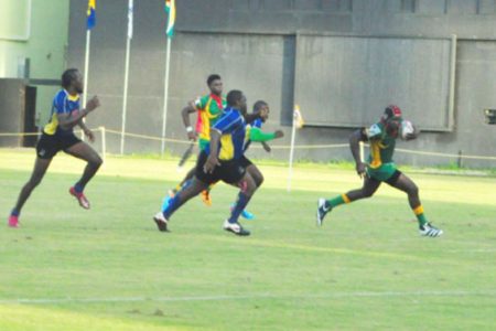 Catch Me If You Can! Guyana’s Avery Corbin sprints to record one of his two tries yesterday in the NACRA Senior Men’s 15 Caribbean Championships game against Barbados yesterday at the Providence National Stadium. (Orlando Charles photo)