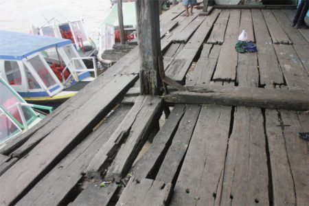 Watch your step – This is the warning to persons using the wharf because of the holes in the flooring (Photo by Arian Browne)
