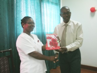 Retired nurse Eileen Benons receiving her gift from NA Hospital CEO Allan Johnson for dedicating over 35 years of service to the health sector 