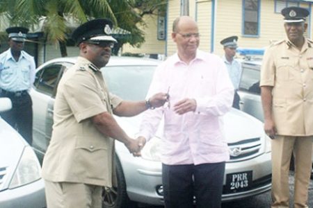 Minister of Home Affairs Clement Rohee (right) hands over the keys to the vehicles to Acting Police Commissioner Leroy Brumell. (GINA photo)