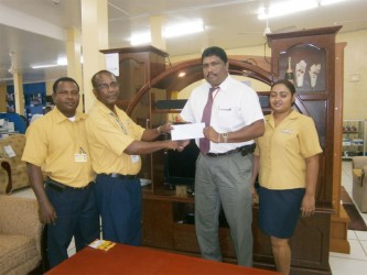  Anil Beharry (second from right) receiving the cheque from Stanley McKenzie 