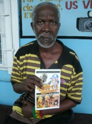  Ivelaw James holds a copy of his new book of poetry