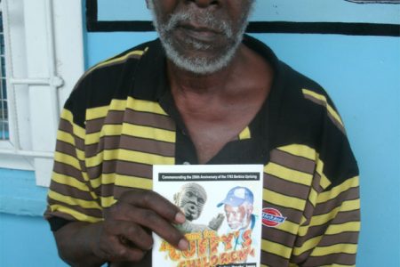 Ivelaw James holds a copy of his new book of poetry