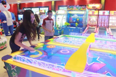 Teenagers playing arcade games at the Princess Hotel Fun City opening yesterday (Photo by Arian Browne) 