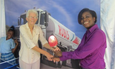 Rubris Retail Account Executive Rhonda Johnson (right) hands over the gear to Sabine McIntosh of DAG 
