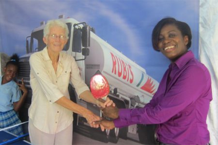 Rubris Retail Account Executive Rhonda Johnson (right) hands over the gear to Sabine McIntosh of DAG
