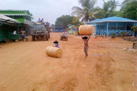 The two brothers, who are said to be two of about nine siblings involved in child labour at Itaballi, are seen transporting drums.
