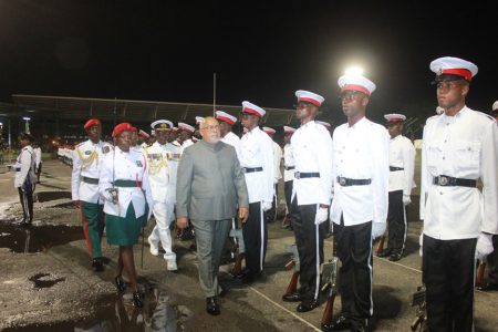 President Donald Ramotar inspecting the guard of honour last night at the National Park for the 47th Independence anniversary flag-raising
