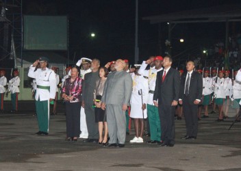 Eyes lifted as the Golden Arrowhead rises. From right in front row are President Donald Ramotar, First Lady Deolatchmee Ramotar, Prime Minister Samuel Hinds and his wife, Yvonne Hinds.