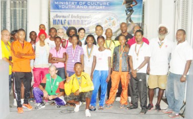 The Half Marathon winners after the presentation ceremony yesterday morning at the Ministry of Culture, Youth and Sports with Dr. Frank Anthony, Alfred King and National Sport Commission Director Neil Kumar.