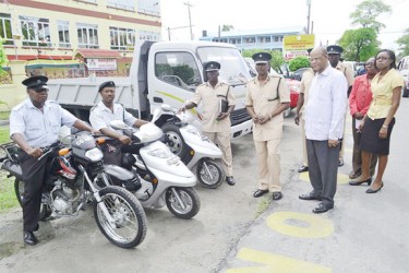 Minister of Home Affairs Clement Rohee (right) and Director of Prisons Dale Erskine (second from right) yesterday inspecting a number of vehicles and motorcycles that the Ministry purchased on its behalf.
