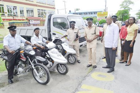 Minister of Home Affairs Clement Rohee (right) and Director of Prisons Dale Erskine (second from right) yesterday inspecting a number of vehicles and motorcycles that the Ministry purchased on its behalf.