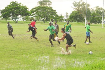 National Rugby captain, Ryan Gonsalves passes the ball to Delroy Gordon during the team’s final practice session yesterday at the National Park before winging out to Trinidad and Tobago this morning. (Orlando Charles photo)