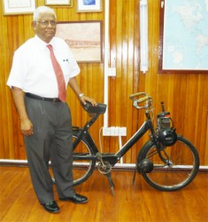 A recent picture of Sattaur Gafoor with a motor-powered cycle, his means of transportation several years ago.