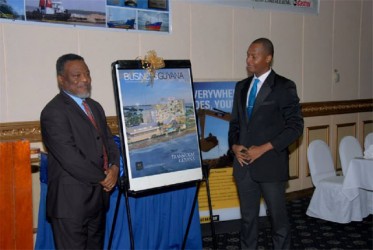 Prime Minister Samuel Hinds and Editor of Business Guyana and President of the GCCI Clinton Urling reveal the cover of the fourth edition of the investment magazine at Tuesday launch. 