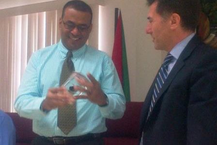 Repsol’s Director of Exploration in Latin America, Joseba Murillas (right) presented Natural Resources Minister Robert Persaud with a sample of oil drilled from the Jaguar-1 well.