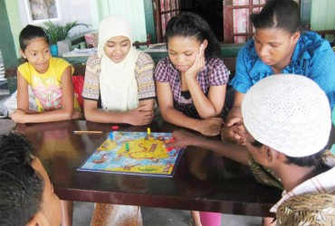 Students of the Tuschen Deaf Academy involved in a game of snakes and the ladders.