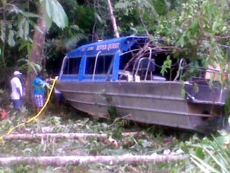 The boat in its crashed position nestled in the bushes just off the Essequibo River bank in the vicinity of Tiger Creek.