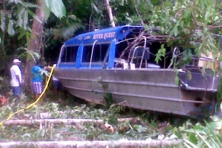 The boat in its crashed position nestled in the bushes just off the Essequibo River bank in the vicinity of Tiger Creek.
