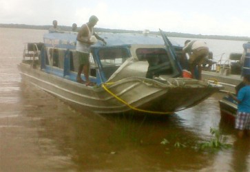 Persons bringing the boat to dock at the Bartica pier yesterday afternoon  