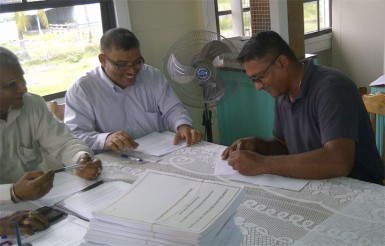 Signing contracts at the Mahaicony/Abary Neighbourhood Democratic Council on Wednesday 