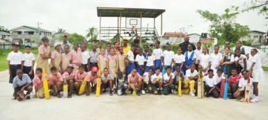  Students, teachers and cricket coach Daniel Richmond (in the middle) at the Agricola Basketball court yesterday. 