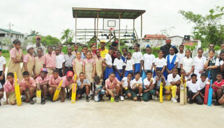  Students, teachers and cricket coach Daniel Richmond (in the middle) at the Agricola Basketball court yesterday.