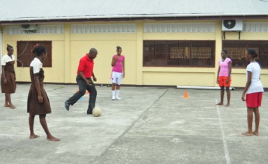 Head Coach Andel Bethune conducting drills with some of the Tutorial High School players Thursday afternoon in the school’s compound, Woolford Avenue (Photo by Orlando Charles). 