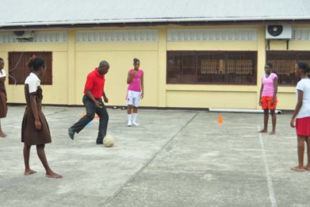 Head Coach Andel Bethune conducting drills with some of the Tutorial High School players Thursday afternoon in the school’s compound, Woolford Avenue (Photo by Orlando Charles).