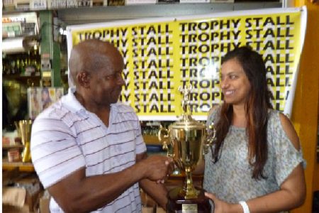 Devi Sunich, wife of Ramesh Sunich, the proprietor of the Trophy Stall hands over the Mr. Fitness Paradise winner’s trophy to Donald Sinclair, owner of Fitness Paradise Gym.