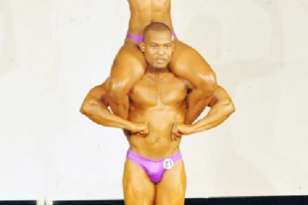 Mr. Fitness Paradise, Orlando Dublin and Fitness Paradise Gym Member of the Year, Shawnell Warner posing during their award winning mix pair’s routine on Sunday. (Orlando Charles photo)