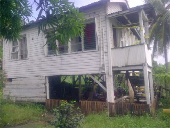 Police tape bars the stairs and doors of the house in which Vanessa Seeram’s body was found 