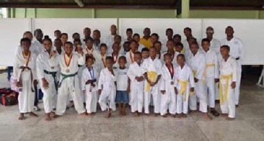 The students who participated in the championships pose with Sensei Winston Dunbar, Darren Nurse President of the Guyana Wado Ryu Karate Association and other officials. 