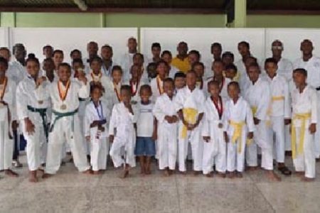 The students who participated in the championships pose with Sensei Winston Dunbar, Darren Nurse President of the Guyana Wado Ryu Karate Association and other officials. 