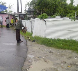 A GPL employee removing illegal connections after disconnecting them from an electricity pole in North Sophia. It is believed that Police Constable Dorwin Pitman who was chasing after a prisoner was electrocuted when he came into contact with illegal livewires.