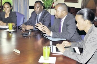 Julian Robinson, minister of state in the Ministry of Science, Technology, Energy and Mining, gestures while addressing yesterday’s Jamaica Observer Monday Exchange. Flanking him are (from left) Tracey-Ann Johnson, acting head of the Cybercrimes Unit in the Office of the Director of Public Prosecutions; Inspector Warren Williams, head of the police Cybercrimes Unit; and Wahkeen Murray, chief technical director in the Ministry of Science, Technology, Energy and Mining. 