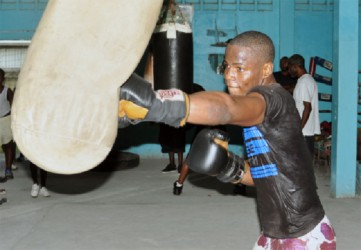 Laured ‘Nightmare’ Stewart going hard at the punching bag ahead of his June 29 ring date during his workout yesterday at the Forgotten Youth Foundation (FYF) gym yesterday. (Orlando Charles photo)