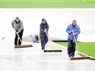 Workmen trying to get rid of the water following a momentary break by the inclement weather which duly returned  and brought a premature end to what was shaping up to be a fascinating finish between the West Indies and South Africa in their Champions Trophy quarter-final clash yesterday. (Cricket 365 photo)