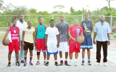 Some members of the Guyana national female basketball team  surrounded by members of the training staff.