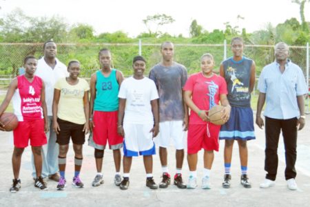 Some members of the Guyana national female basketball team  surrounded by members of the training staff.