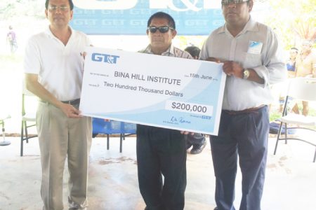 GT&T yesterday donated $200,000 to the Bina Hill institute in North Rupununi to assist with the development and sustainment of the institute.  From left: GT&T CEO R K Sharma , Chairman of the NRDDB Michael Williams and CEO of NRDDB Ivor Marslow hold up the cheque. 