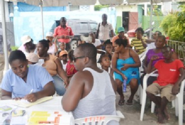 Residents of Rasville awaiting medical treatment at the medical outreach (GINA photo) 