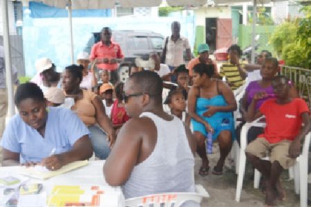 Residents of Rasville awaiting medical treatment at the medical outreach (GINA photo)