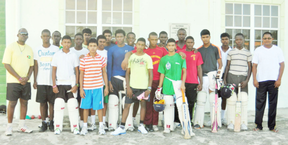 At left Coach Garvin Nedd, the U17 team and Manager Nazeer Mohamed at the Chetram Singh Centre of Excellence, (LBI), East Coast Demerara yesterday. 