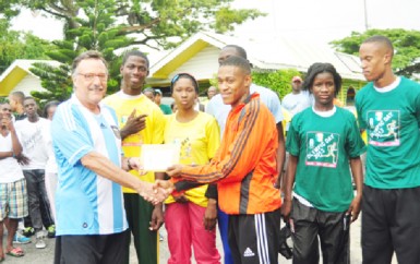 Argentina’s Ambassador to Guyana Luis Alberto Martino presents an envelope to Police’s A team member, Dennis Horatio in the presence of Kevin Bayley, Nathaniel Giddings, Abidemi Charles, Janelle Jonas and Jowyne Johnson.