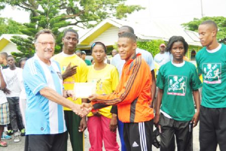 Argentina’s Ambassador to Guyana Luis Alberto Martino presents an envelope to Police’s A team member, Dennis Horatio in the presence of Kevin Bayley, Nathaniel Giddings, Abidemi Charles, Janelle Jonas and Jowyne Johnson.