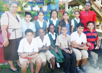 Teachers, Shamena Charran (left) and Magdalene Sobers-Williams posing with the top students of Novar Primary