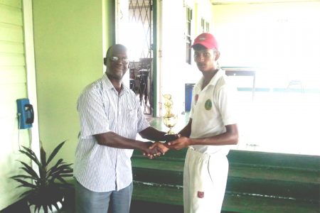 Derek Narine receives his man of the match trophy from Chairman of the GCB Competitions Committee, Colin Europe.