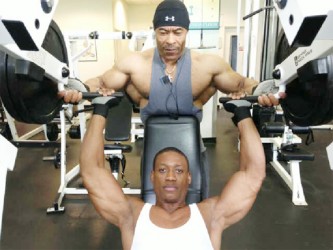 Kerwin ‘Chisel’ Clarke in training with Guyanese world renowned bodybuilder, Hugh Ross at the Brooklyn Sports Club last week.