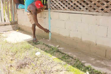 A resident points to the line where the water was at his shop 